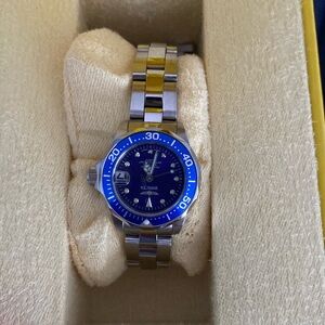 Small face Invicta watch with blue and purple tones.